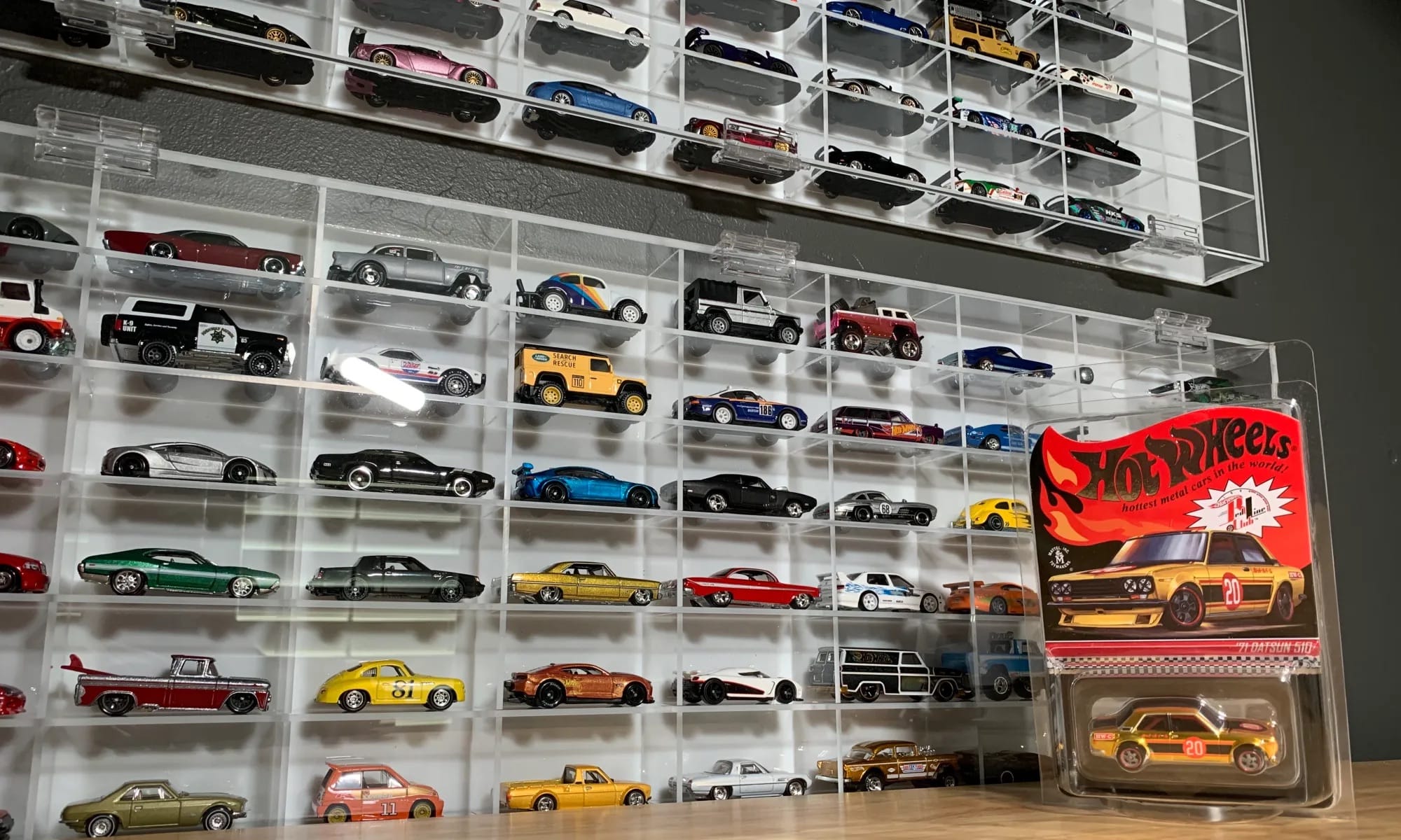 Wall-mounted Hot Wheels collector display showcasing Mainline and Premium cars by series